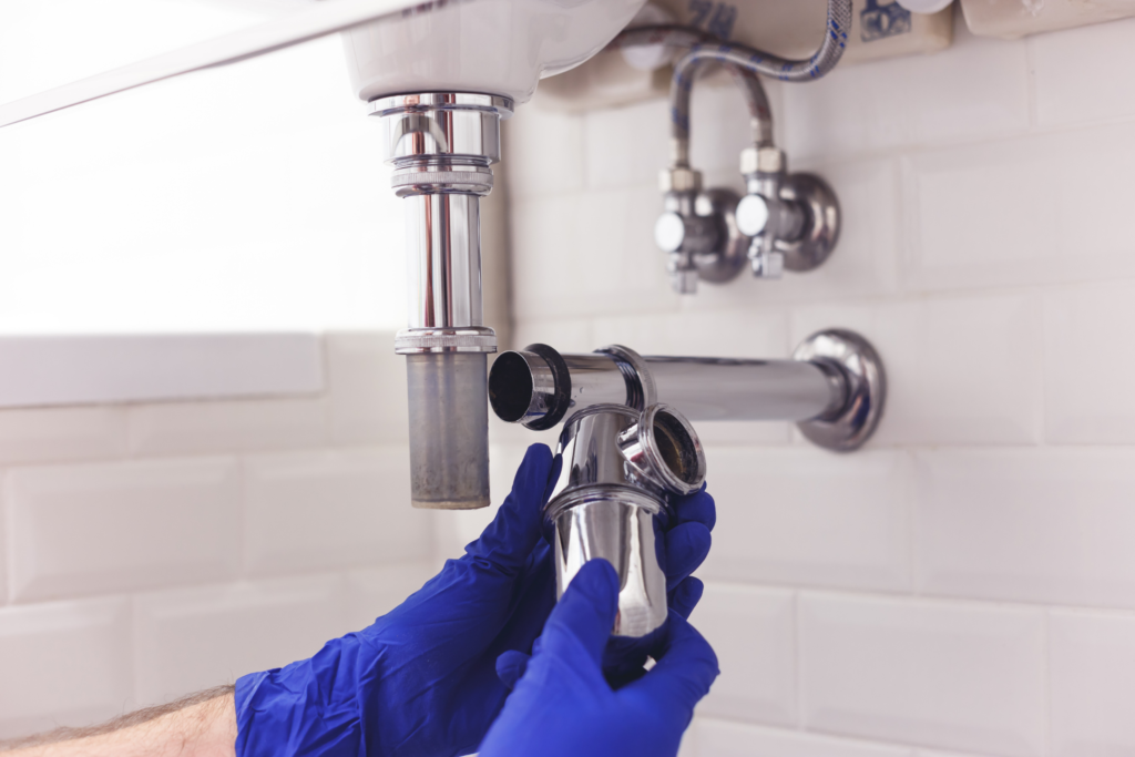 Plumber locating and repairing a leaking pipe in a Chester County, PA home