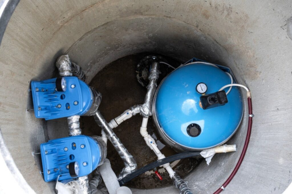Pumps and a pressure tank installed in a concrete basin