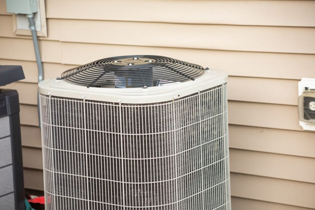 Central air conditioning condenser outside a home